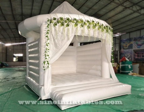 adults wedding all white bouncy castle with Rose decoration